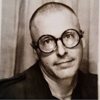 a black and white photo of a man with glasses